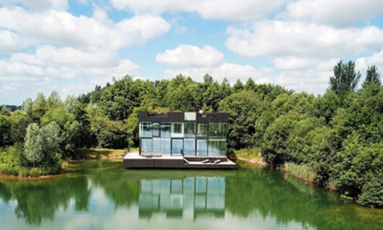 modern house on a lake, amongst forest