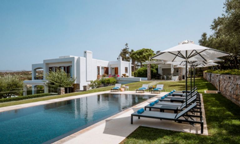 Pool with white villa behind