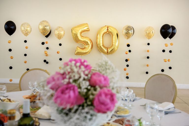 50th birthday balloons and decorations at a table