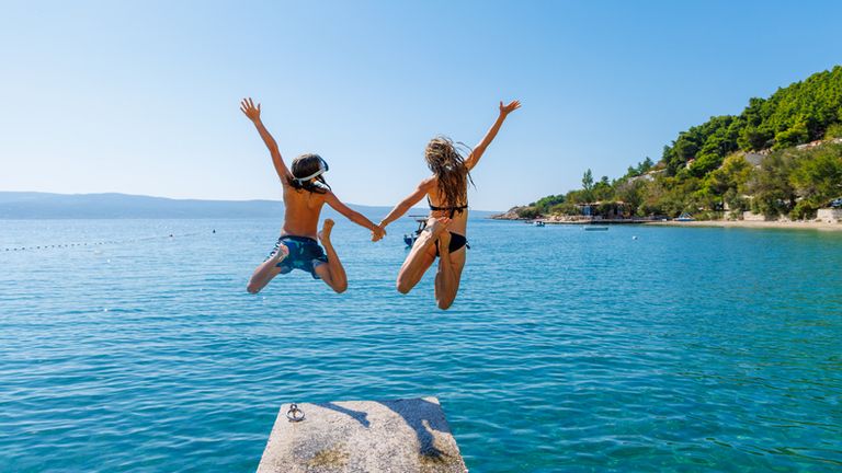 2 kids jumping into the water on holiday in Croatia