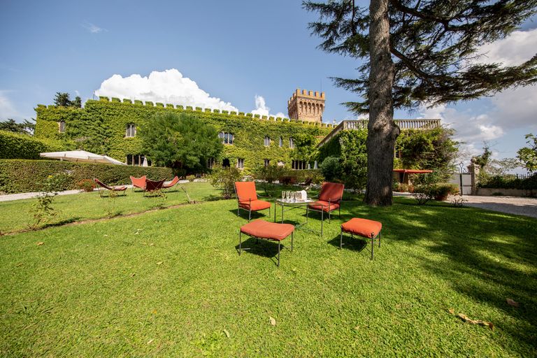 Tuscan castle in Italy, chairs on the grass