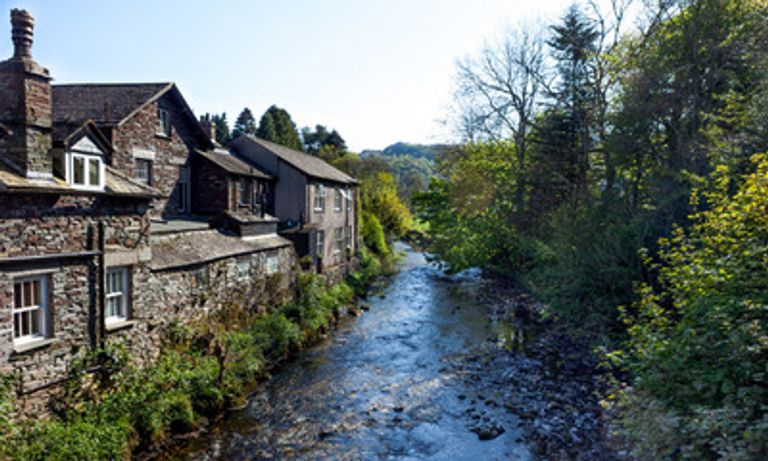 Cottages along a river in Grasmere, The Lake District